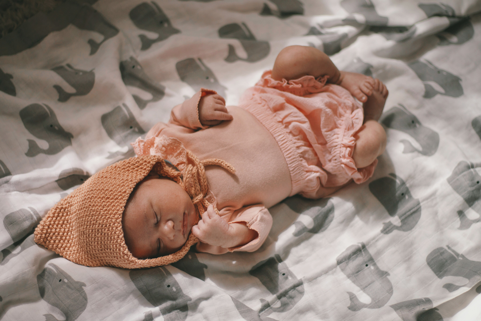 a 10 day old baby dressed in pink